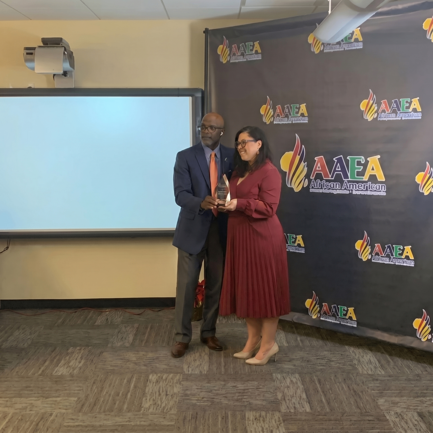 Carmen Ruiz receiving recognition from the African American Entrepreneurs Association